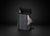 Black backpack with Yonix branding on a black background with water bottole and magazine