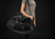 Person holding a black Younix duffel bag against a dark background