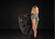Woman wearing a black backpack on a black background